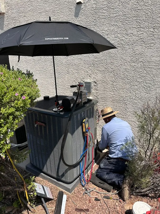 HVAC technician performing outdoor AC maintenance in Beebe